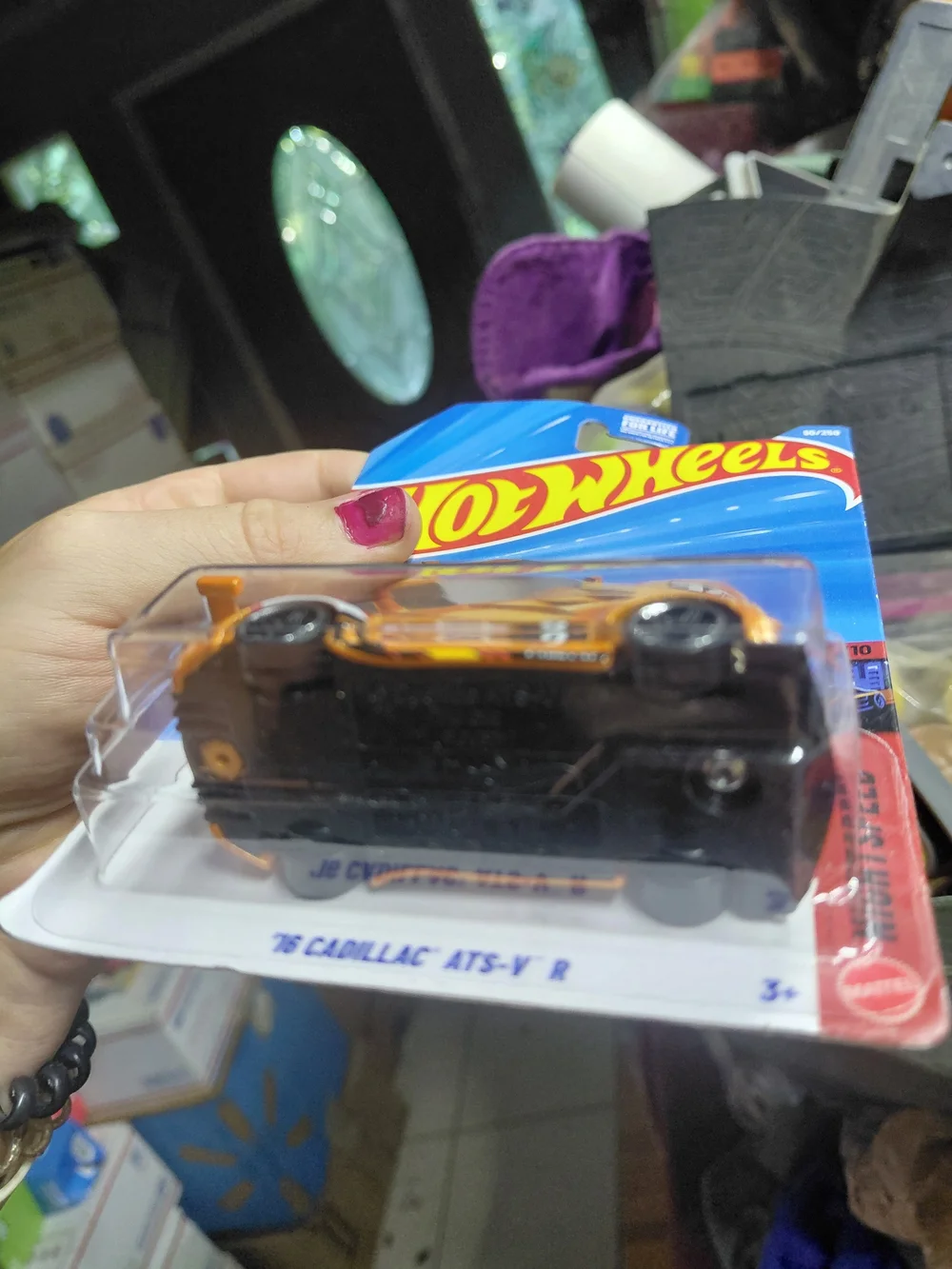The Hot Wheels '16 Cadillac ATS-V R (orange, 90/250) is a 1:64 scale diecast car